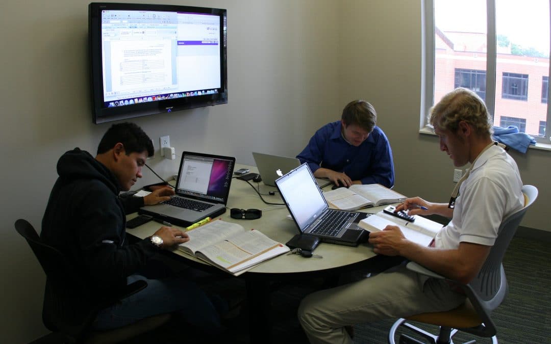 Students working on their laptops in a study area