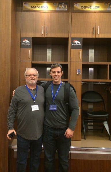 Ryan and his father in front of Denver Broncos quarterback Peyton Manning's locker.