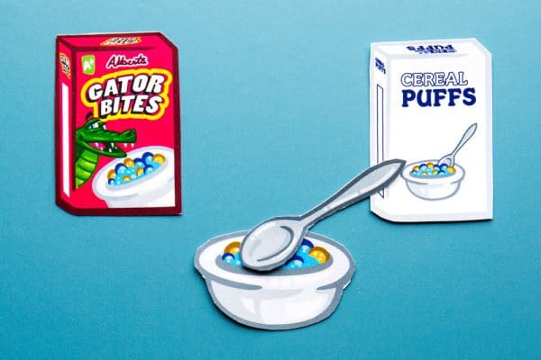 Cartoon-like drawing of cereal boxes and a bowl and spoon with cereal