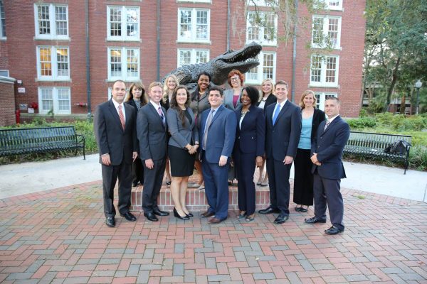 The Business Career Services Team poses for a photo in front of the Gator Ubiquity Statue