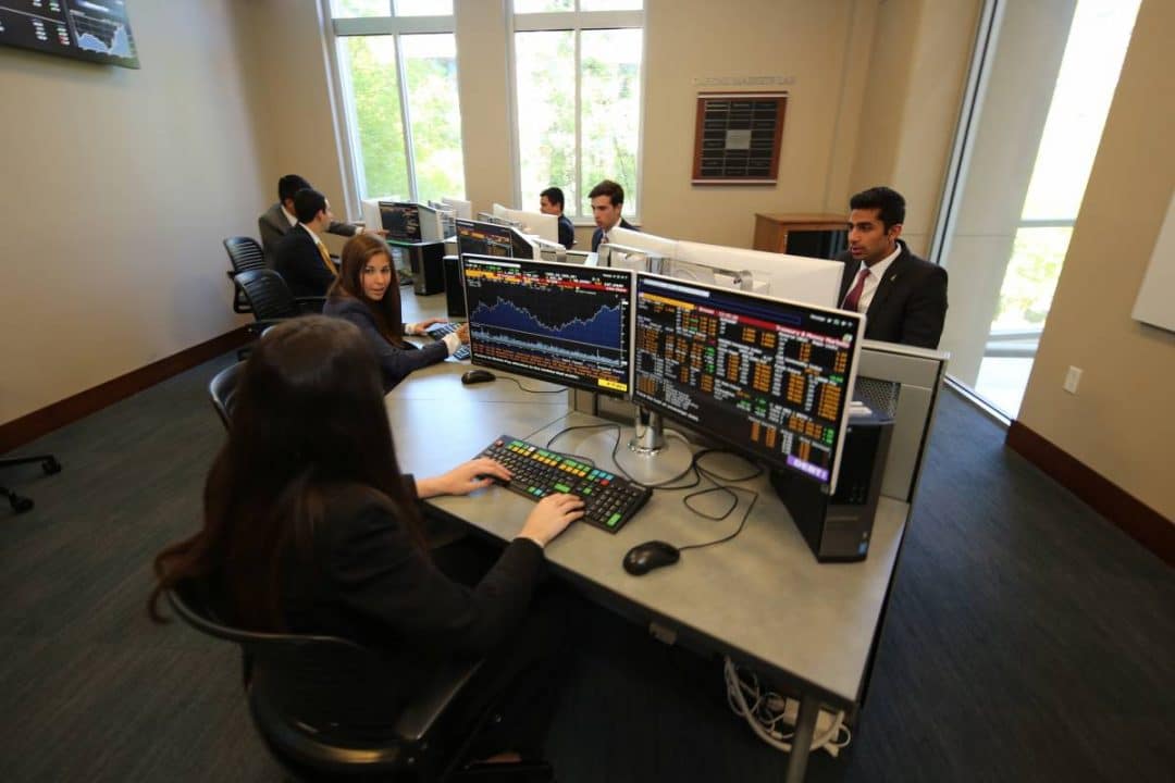 Finance students sit at Bloomberg terminals in the Capital Markets Lab