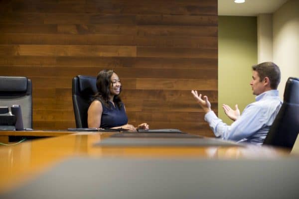 A UF MBA student talking with a member of the Career Services team in a boardroom
