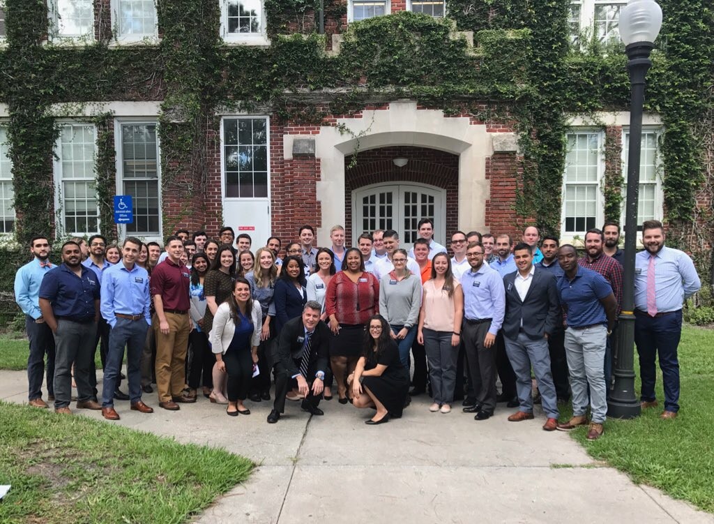 Large group of UF MBA students stand in front of Bryan Hall