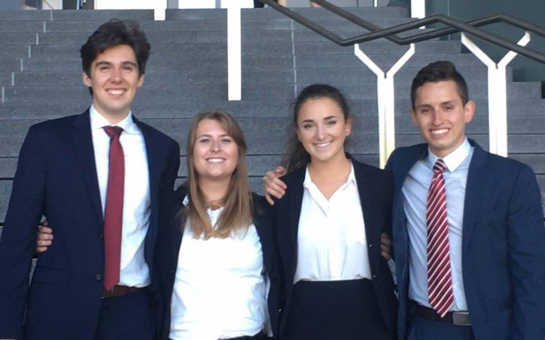 Four students pose for a photo at a case competition