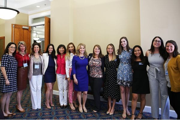 A group of women pose for a photo at the Women's Entrepreneurship Symposium