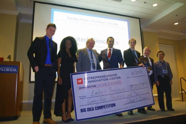 Group of students and faculty stand with a large check at the Big Idea Competition