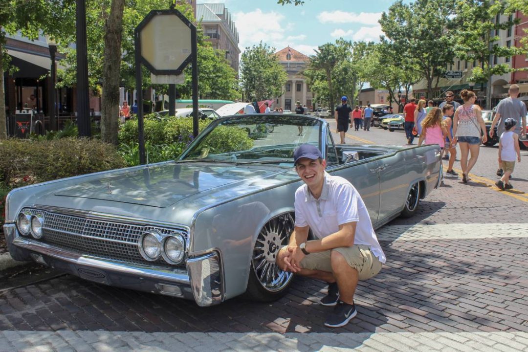 Michael Cizek poses with a classic car