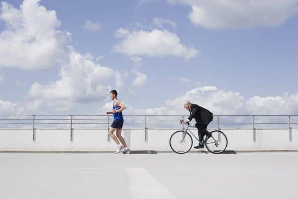 Man running followed by a man on a bike