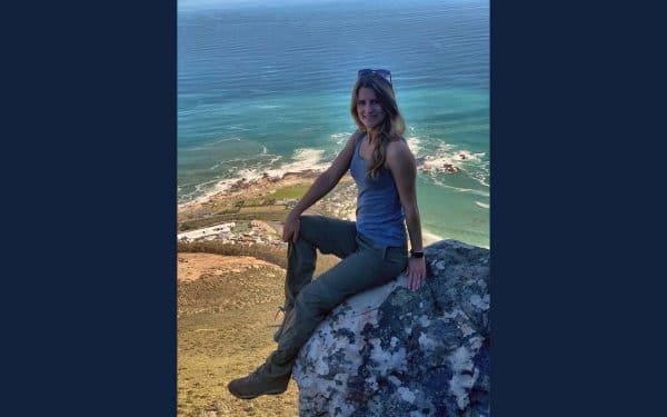 Stefani Harrison sits on a rock in South Africa