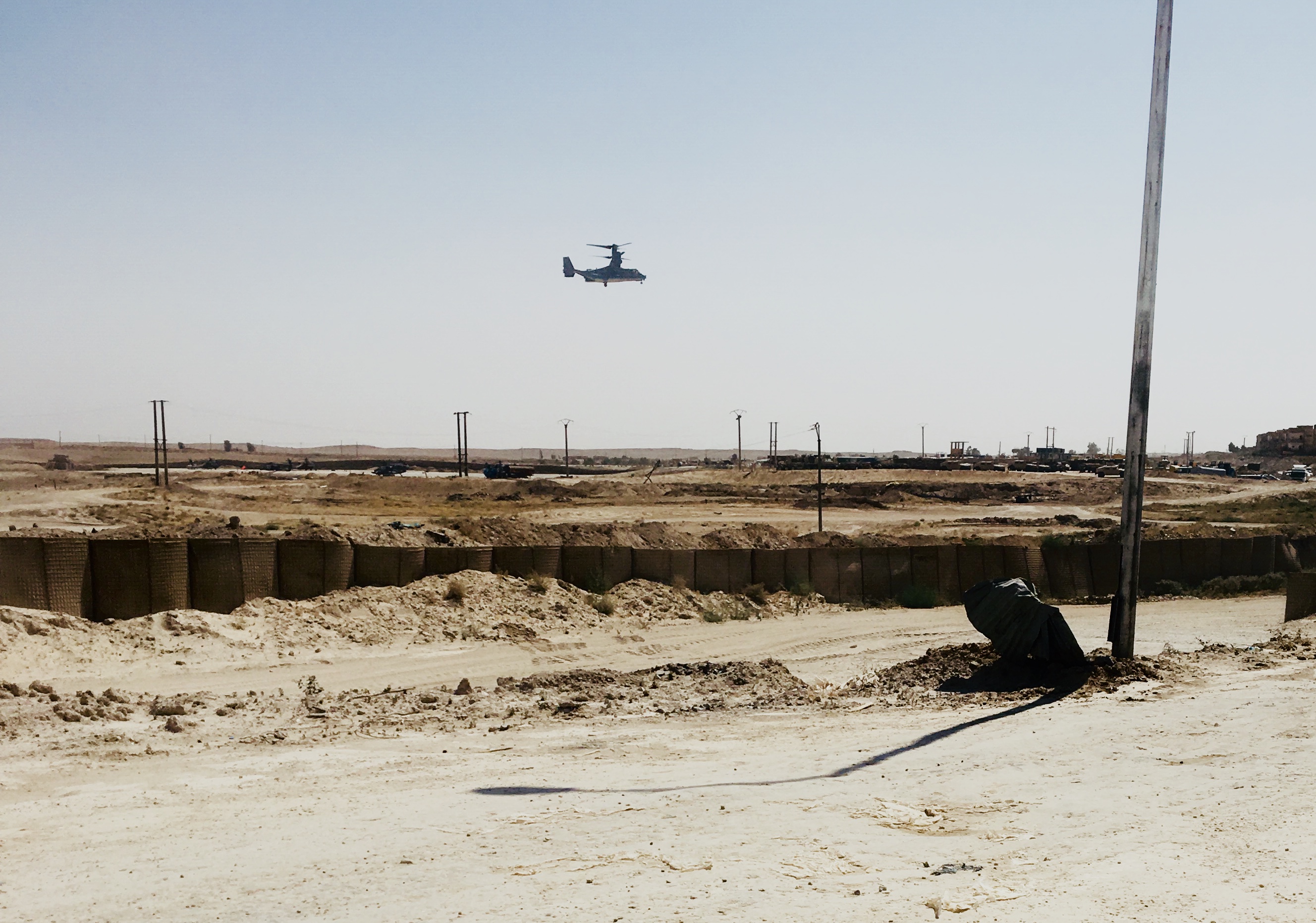 A helicopter landing in the desert.