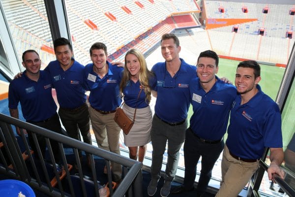 Seven real estate students pose for a photo in Ben Hill Griffin Stadium