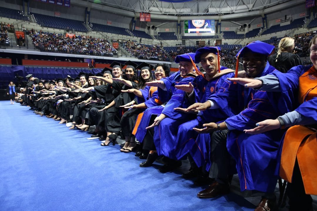 Warrington Fall 2018 graduates do the Gator Chomp in the Stephen C. O'Connell Center at the Fall Graduate Recognition Ceremony