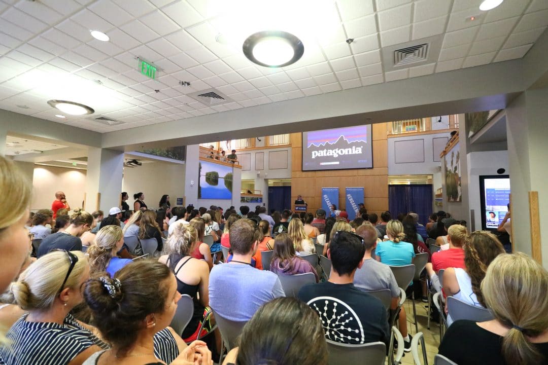 A large room of students listening to a presentation