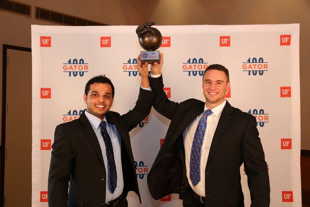 Karthik Shanadi and Luke McGurrin hold up their Gator100 trophy