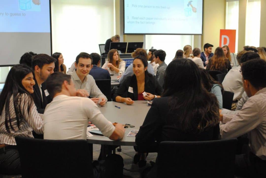 Group of students sitting at a round table talking