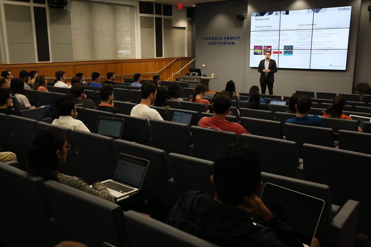 Charles Carmakal speaks to students in Dr. Praveen Pathak's class about the current cybersecurity landscape in February 2019.