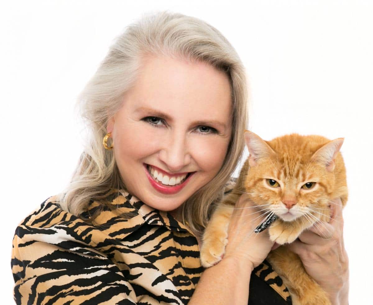 Lynn Maria Thompson author speaker in tiger jacket with cat