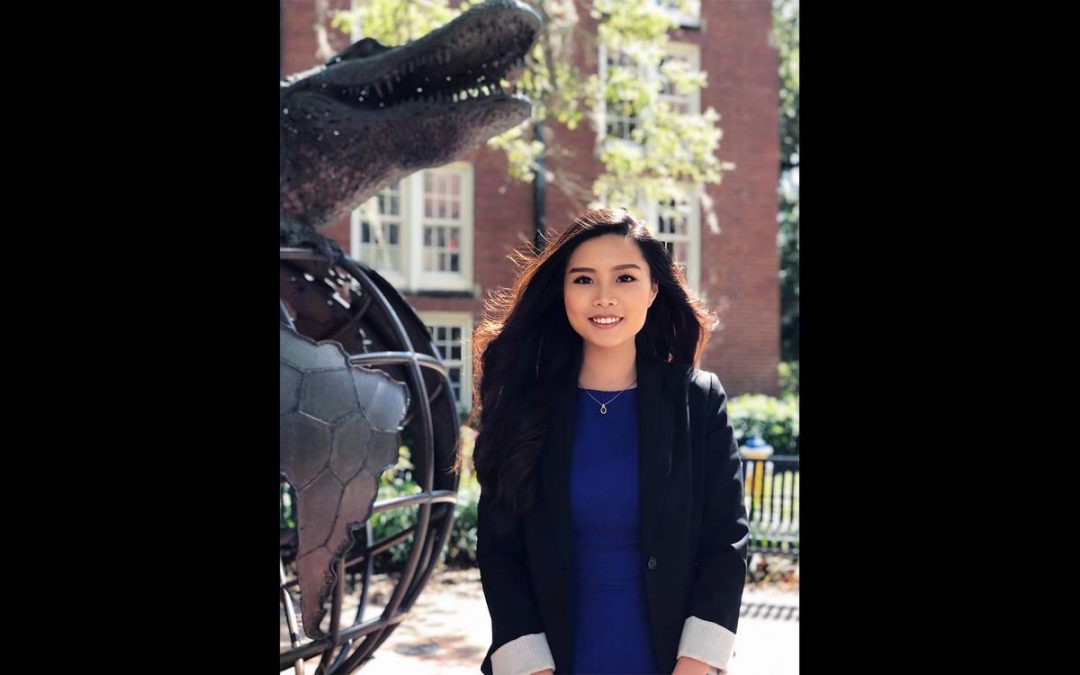 Sandy Liu in front of the Gator Ubiquity Statue