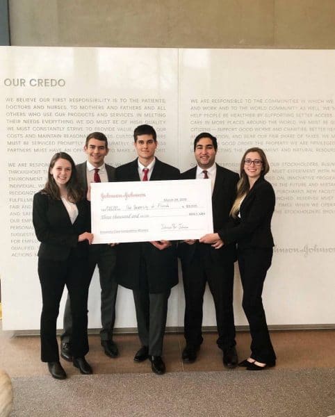 The winning team of Heavener School of Business students with their check from the Johnson & Johnson Case Competition.