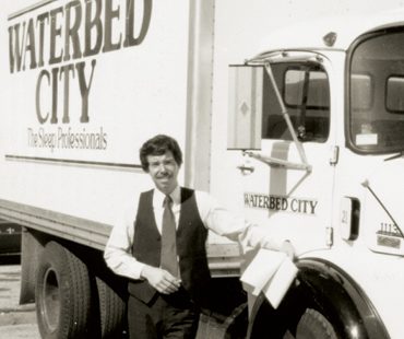 Keith Koenig stands in front of a Waterbed City delivery truck.