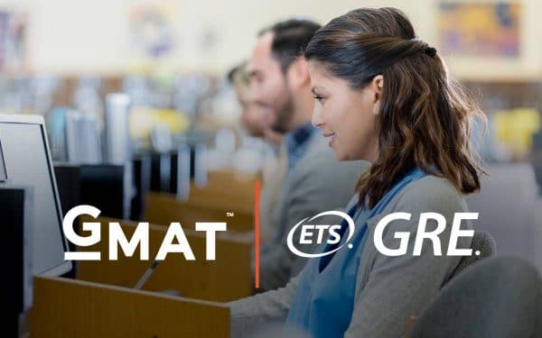 Woman taking a test on a computer with overlay of GMAT and GRE logos