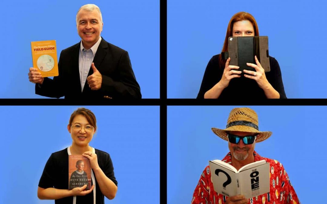 4 Warrington faculty members, two male and two female, hold books. They are positioned in four rectangles on a blue background, similar to the Brady Bunch opening