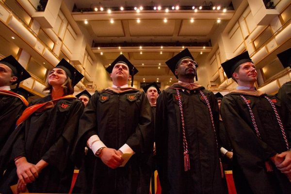 Upward angle of UF MBA students in graduation robes and caps