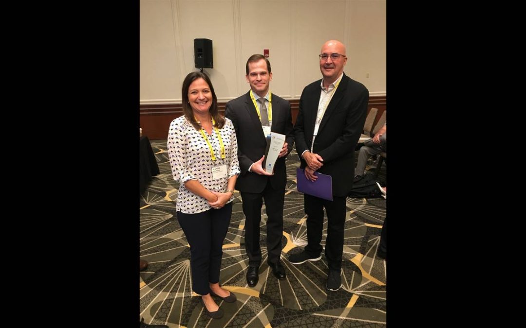 Brian Swider, center, stands with his award from the Academy of Management between two of his advisors Wendy Boswell and Murray Barrick, of Texas A&M University.