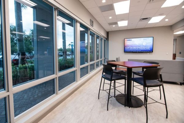 Lounge area with tables and couches for students in UF MBA South Florida Miramar location