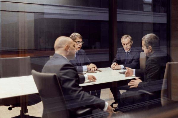 Executive businessmen talking in a dark meeting room