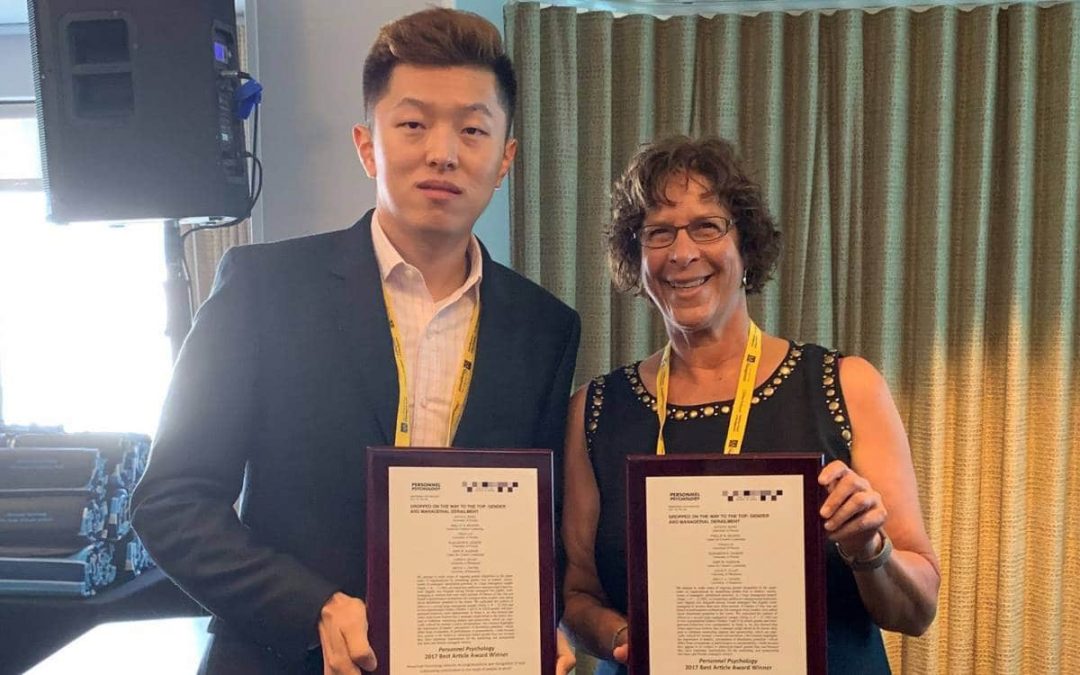 Yihao Liu and Joyce Bono hold their awards from Personnel Psychology