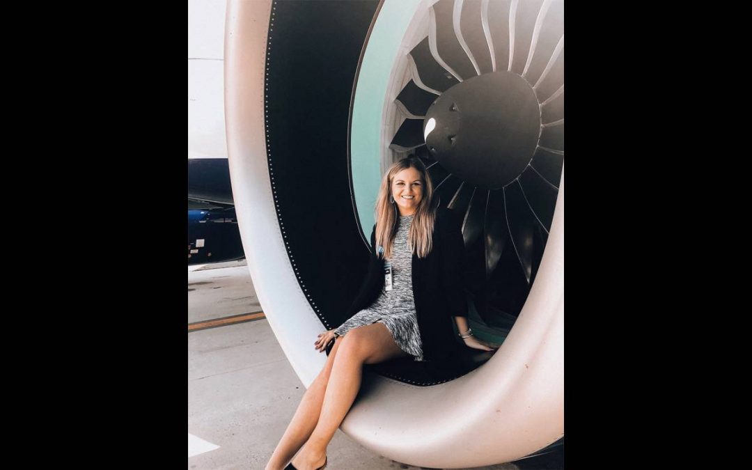 Emma Magee sits in the engine of an airplane