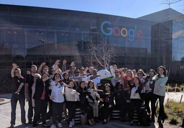 Large group of students do the Gator Chomp in front of Google