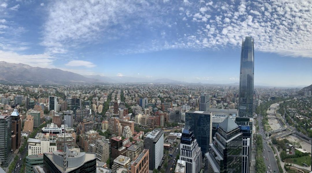View of Santiago, Chile. Many buildings with mountains in the background.