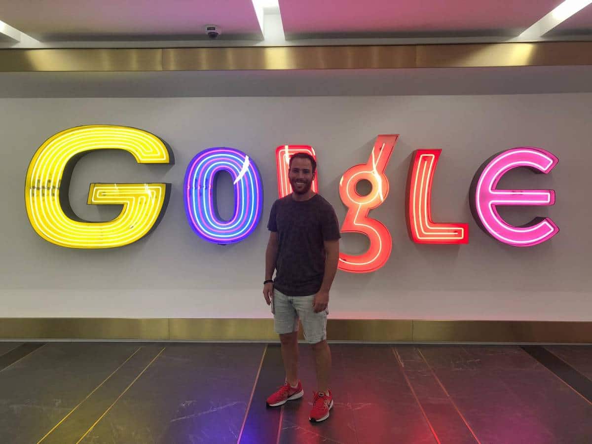 Henri Rojzman stands in front of the Google logo