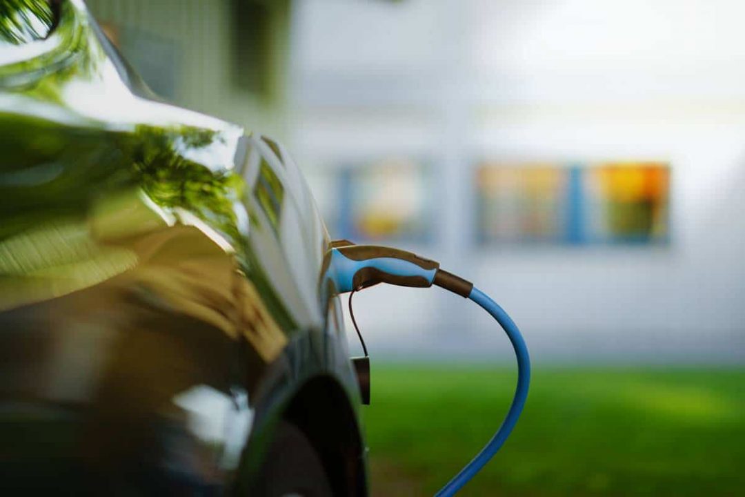 Side view of an electric car being charged