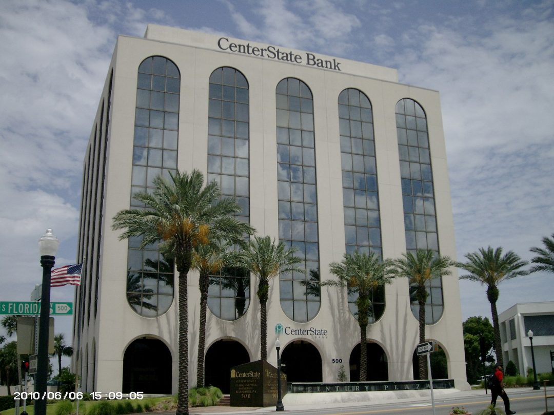 Multi-story building with large long windows with CenterState Bank logo at top of the building