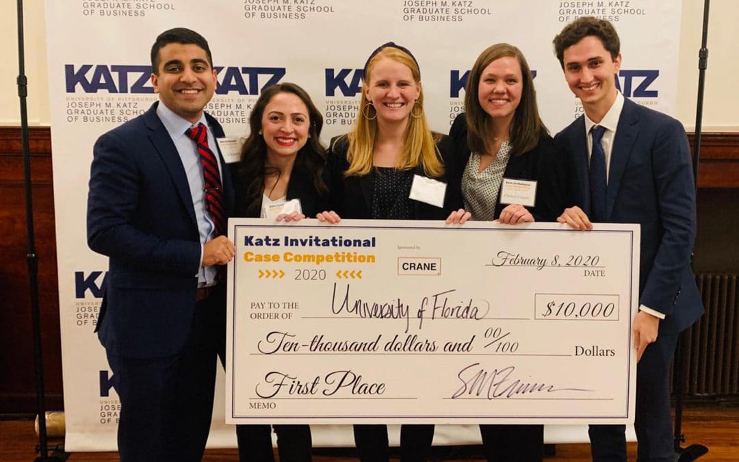 Four UF MBA students and their advisor hold their large $10,000 check from the Katz Case Competition