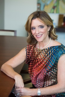 Alison Rand sits at a boardroom table