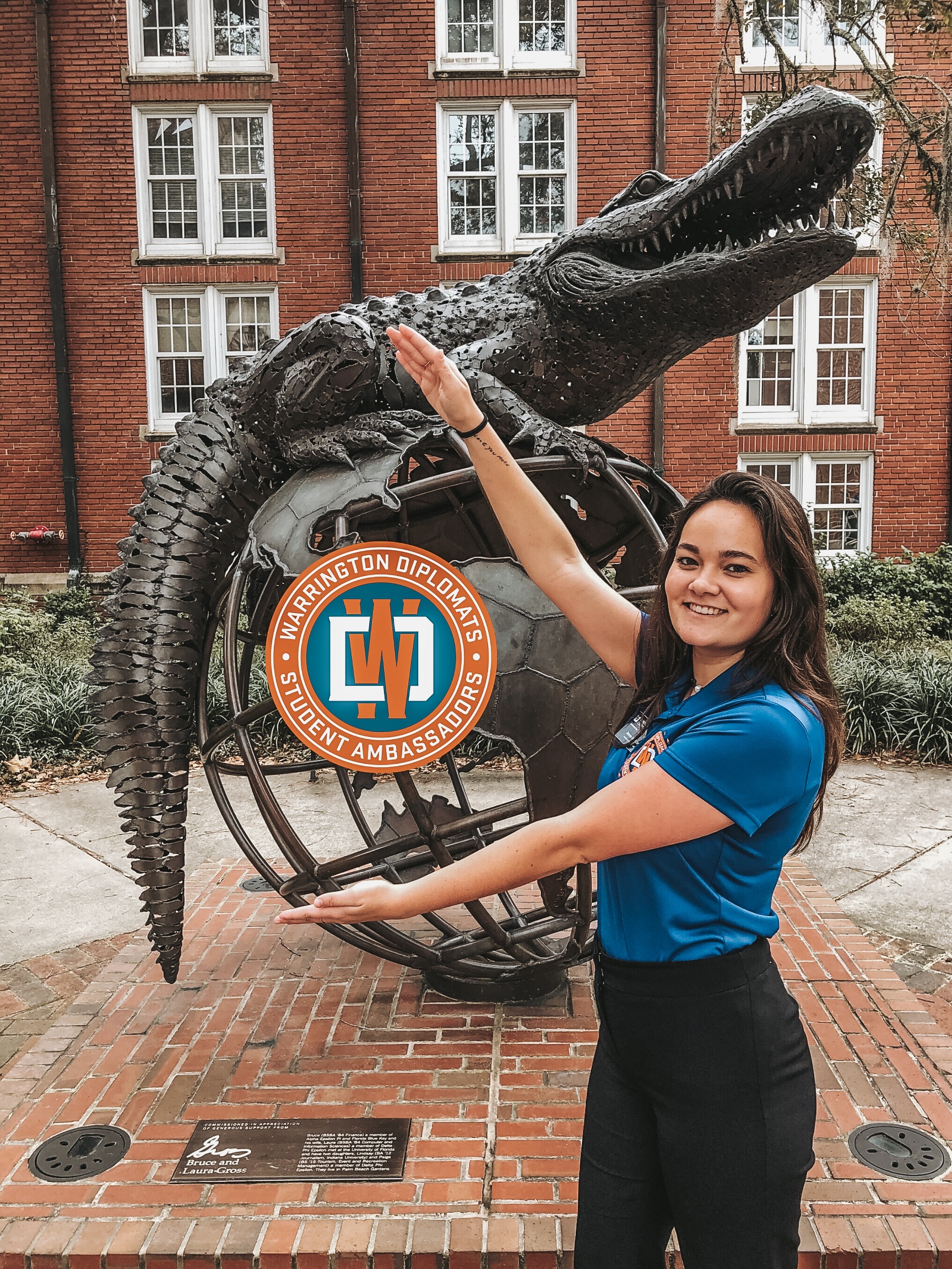 Jenna Griffiths does the Gator Chomp in front of the Gator Ubiquity Statue