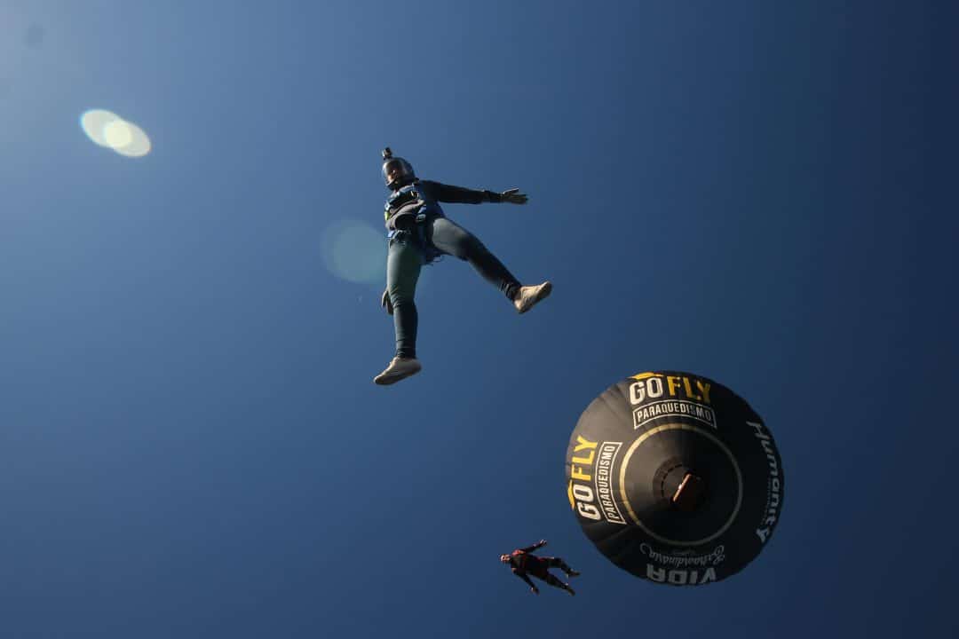 Emily Bombardi skydiving in Brazil with a balloon behind her