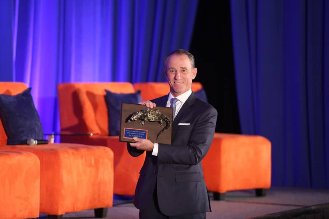 Rick Scarola holds his 2016 Bergstrom Center Alumnus of the Year award