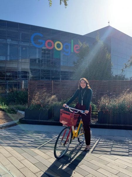 Nelly Wilson sitting on a bike outside of Google's headquarters.