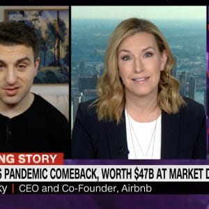 Airbnb CEO speaks on screen with CNN reporter about the company's IPO