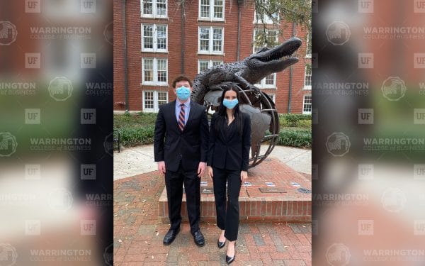 Jacob Orlick and Savannah LoPiccolo stand in front of the Gator Ubiquity Statue
