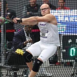 Thomas Mardal winds up to make his hammer throw during a track and field event.