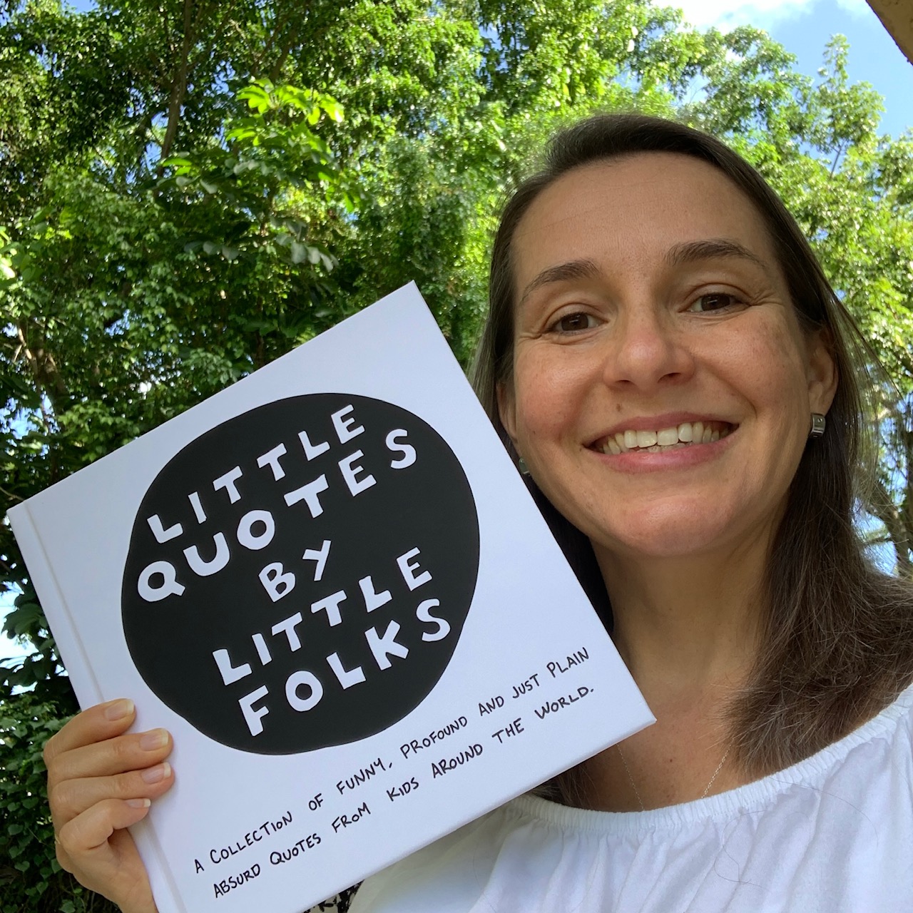 Rebecca Carter holds a copy of her book, Little Quotes by Little Folks.