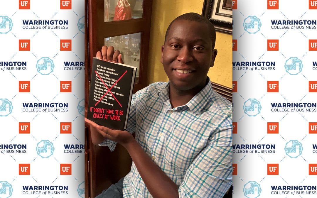 Warrington alumnus Brandon Harris holds a copy of his book recommendation, It Doesn't Have to be Crazy to Work.
