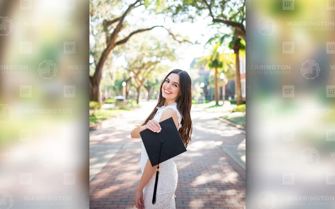 Sandra Cardenal poses on UF's campus with her graduation cap