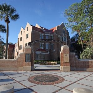 Heavener Hall in the background with the UF Archway and seal in the foreground.